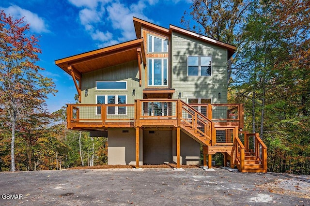 rear view of property featuring a wooden deck