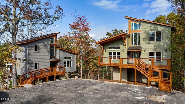 back of property with a wooden deck