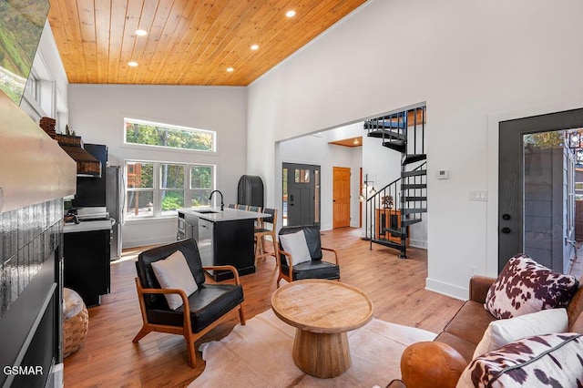 living room featuring sink, high vaulted ceiling, wooden ceiling, and light hardwood / wood-style floors