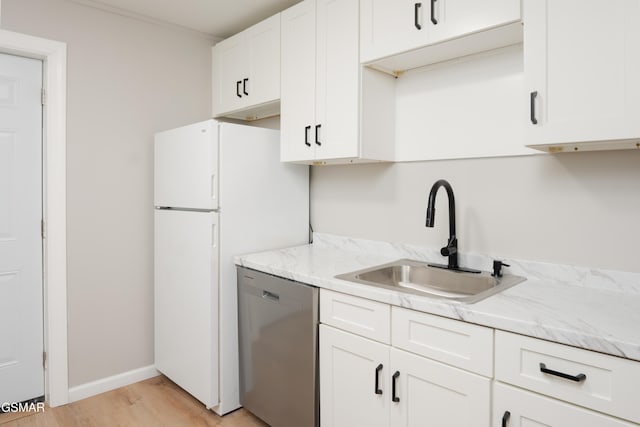 kitchen featuring a sink, light wood-type flooring, white cabinetry, and dishwasher