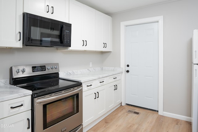 kitchen with visible vents, white cabinets, light wood-type flooring, stainless steel range with electric stovetop, and black microwave