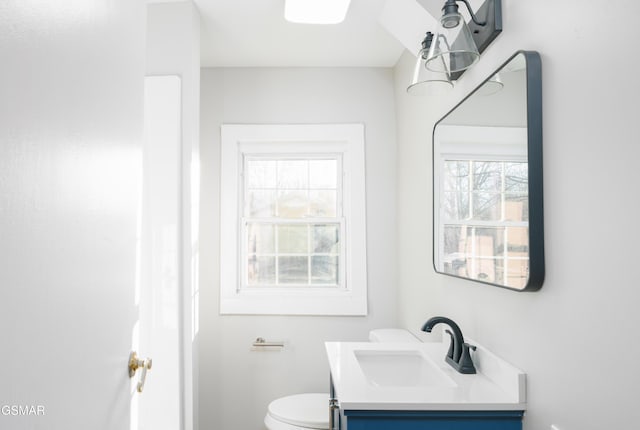 bathroom featuring toilet and vanity