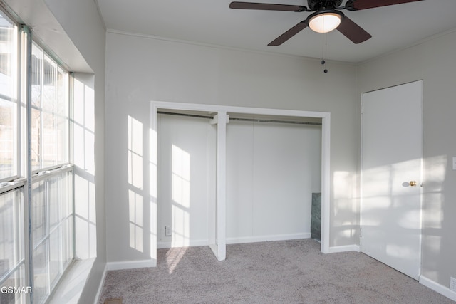 unfurnished bedroom featuring ornamental molding, carpet flooring, and baseboards