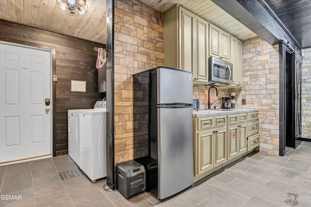 3501 Ginseng Way, Sevierville, TN 37862 - kitchen with appliances with stainless steel finishes, cream cabinets, a sink, wood ceiling, and wooden walls