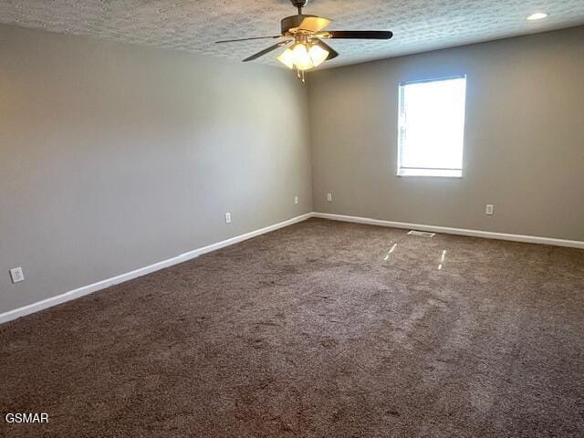 carpeted empty room with a ceiling fan, a textured ceiling, and baseboards