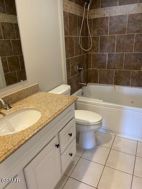 full bath featuring toilet, shower / bath combination, vanity, and tile patterned floors