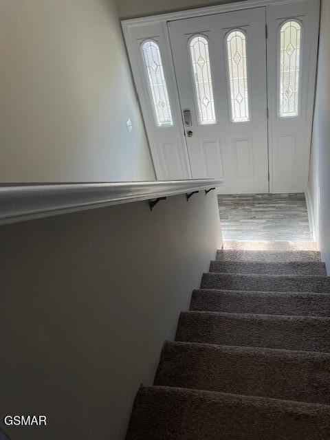 stairway featuring wood finished floors