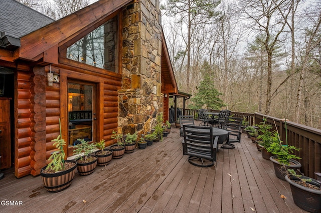 wooden deck featuring outdoor dining area