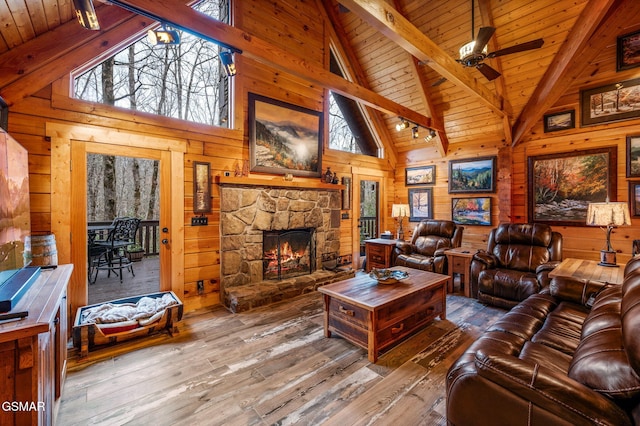 living area with wooden walls and wooden ceiling