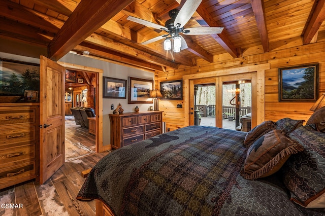 bedroom with wooden walls, beam ceiling, wooden ceiling, wood finished floors, and access to outside