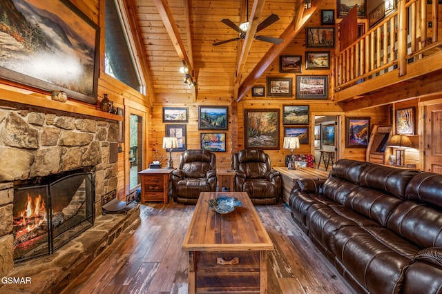 living area with beam ceiling, dark wood finished floors, wooden ceiling, wood walls, and a fireplace