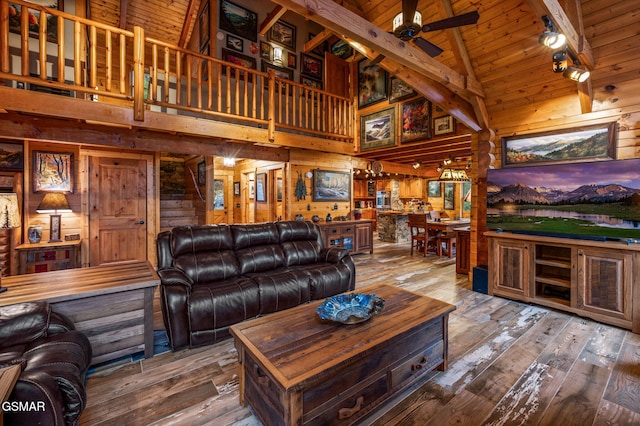 living room featuring wooden walls, ceiling fan, stairway, hardwood / wood-style floors, and wooden ceiling