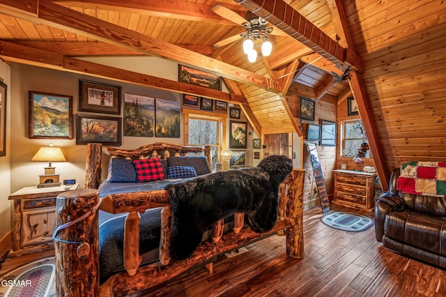 bedroom with wooden ceiling, vaulted ceiling with beams, wood finished floors, and wood walls