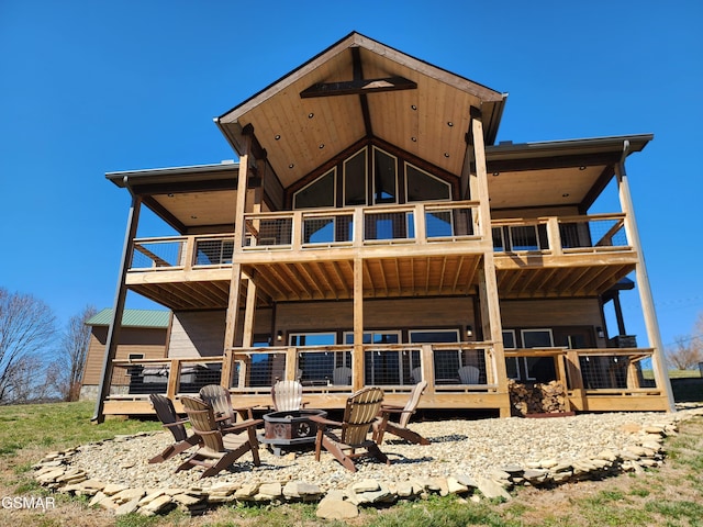 rear view of house with an outdoor fire pit