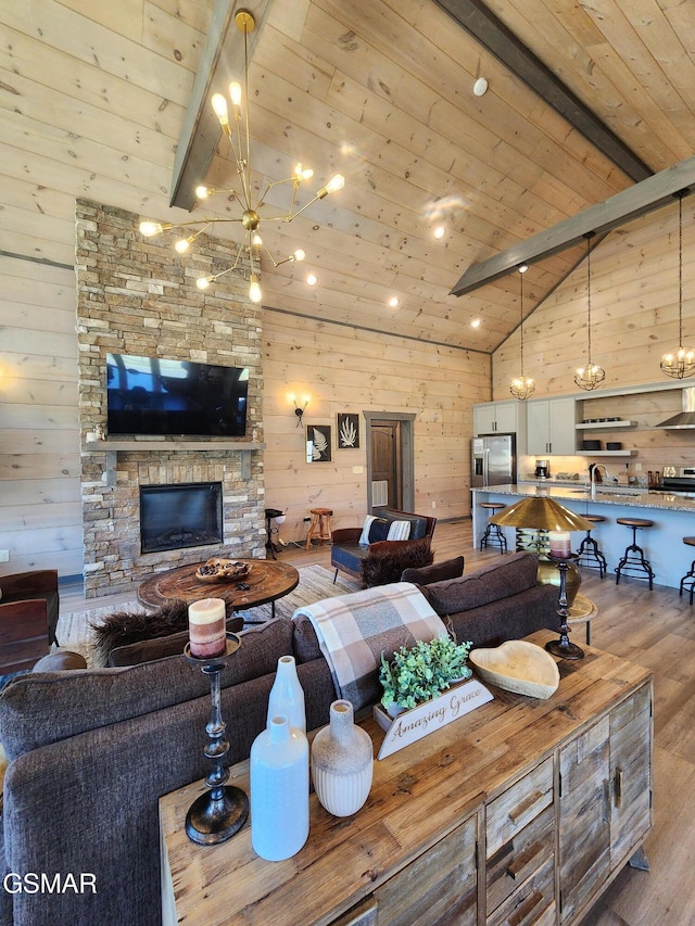living room with wood walls, wood finished floors, wood ceiling, and a notable chandelier