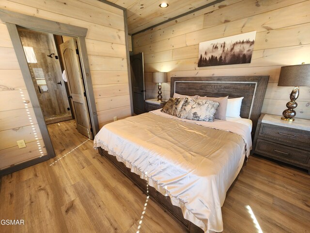 bedroom with wood walls and wood finished floors