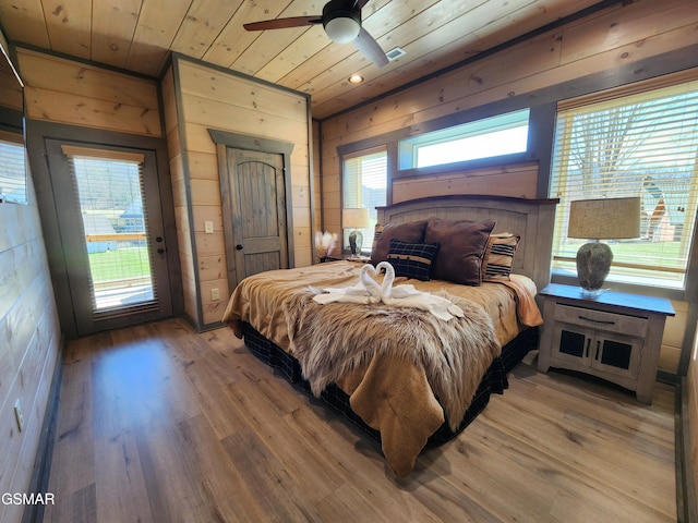bedroom featuring wooden ceiling, access to outside, wooden walls, and light wood-style floors