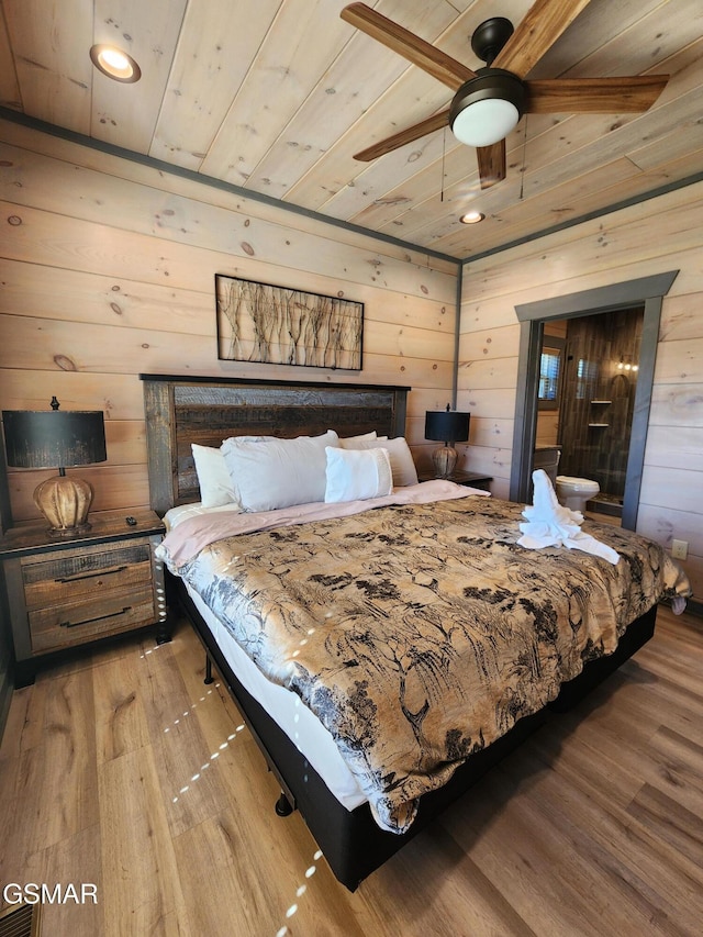 bedroom with wood walls, wood finished floors, and wood ceiling