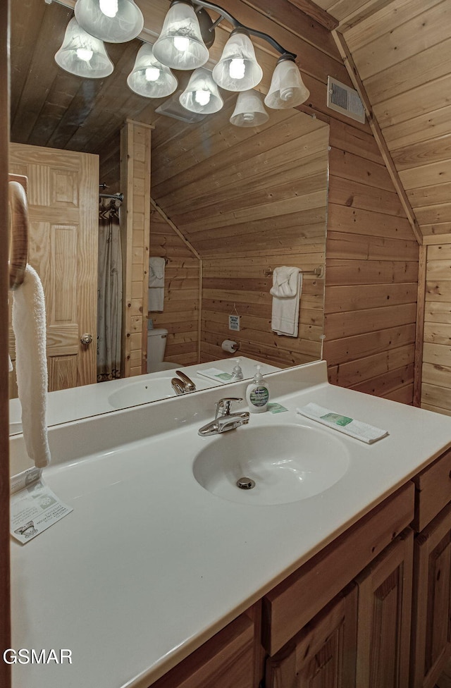 1482 Red Cedar Ln Unit 64, Sevierville, TN 37876 - bathroom with wood ceiling, lofted ceiling, wooden walls, vanity, and a shower