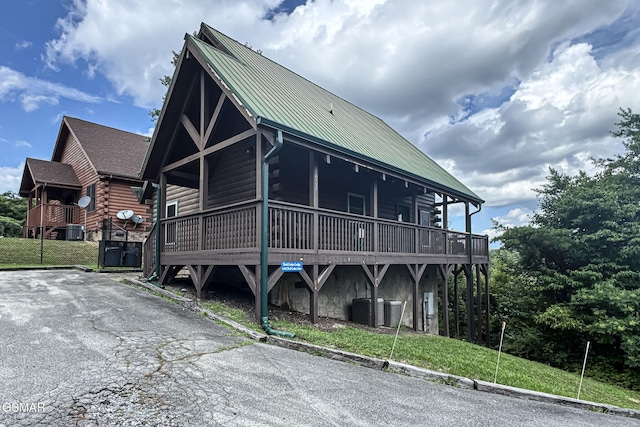1482 Red Cedar Ln Unit 64, Sevierville, TN 37876 - cabin featuring log siding, a metal roof, and a deck