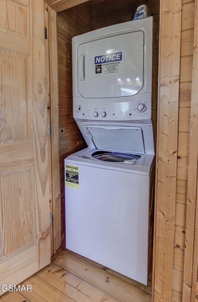 1482 Red Cedar Ln Unit 64, Sevierville, TN 37876 - laundry room with stacked washer / drying machine, light wood finished floors, and wood walls
