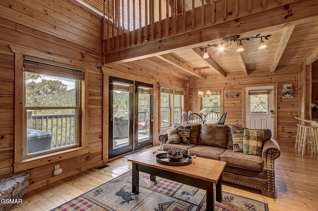 1482 Red Cedar Ln Unit 64, Sevierville, TN 37876 - living room featuring wooden walls, track lighting, light wood-style flooring, a wooden ceiling with exposed beams, and a chandelier