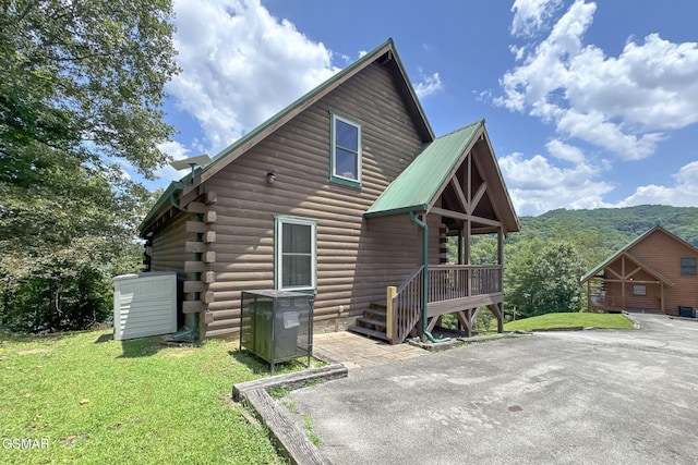 1482 Red Cedar Ln Unit 64, Sevierville, TN 37876 - rear view of house with a lawn, a metal roof, and log exterior