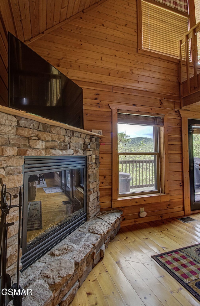 1482 Red Cedar Ln Unit 64, Sevierville, TN 37876 - unfurnished living room featuring a fireplace, wooden walls, hardwood / wood-style floors, wooden ceiling, and high vaulted ceiling