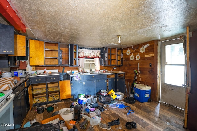 kitchen with a textured ceiling, wooden walls, dark wood-type flooring, white range with electric stovetop, and open shelves