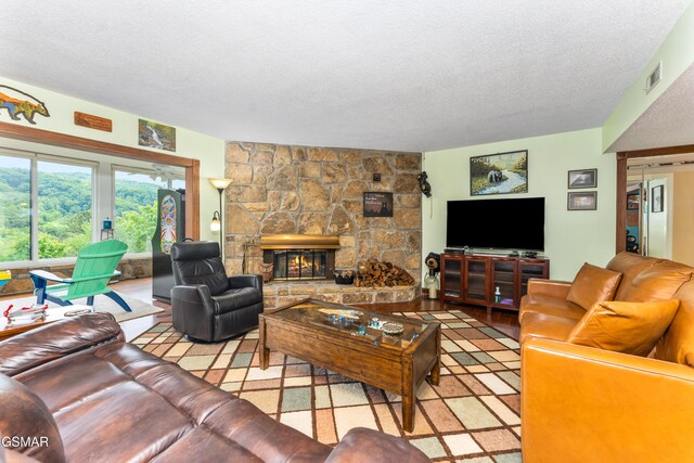 1704 Hidden Hills Rd Unit 504, Gatlinburg, TN 37738 - living room featuring a textured ceiling and a stone fireplace