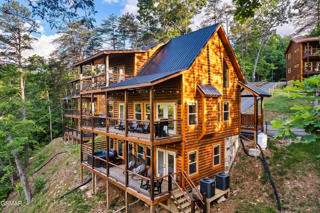 1013 Silver Poplar Ln, Sevierville, TN 37876 - back of property featuring central AC unit, french doors, a deck, and faux log siding