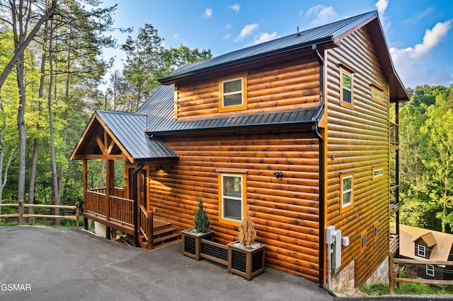 1013 Silver Poplar Ln, Sevierville, TN 37876 - rear view of property featuring faux log siding, metal roof, and a patio area