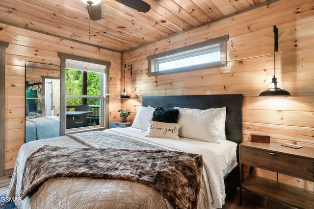 1013 Silver Poplar Ln, Sevierville, TN 37876 - bedroom with wooden walls, multiple windows, wooden ceiling, and a ceiling fan