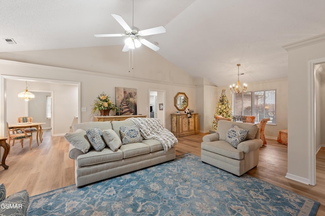 living room featuring hardwood / wood-style flooring, ceiling fan with notable chandelier, and lofted ceiling