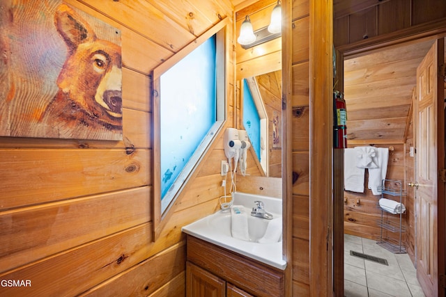 bathroom featuring wood walls, vanity, and tile patterned floors