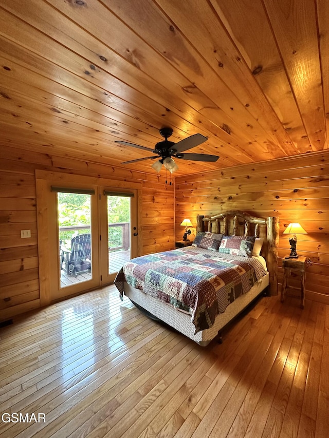 2973 Mockingbird Way, Sevierville, TN 37862 - bedroom featuring access to exterior, light wood-style flooring, wood walls, and wood ceiling