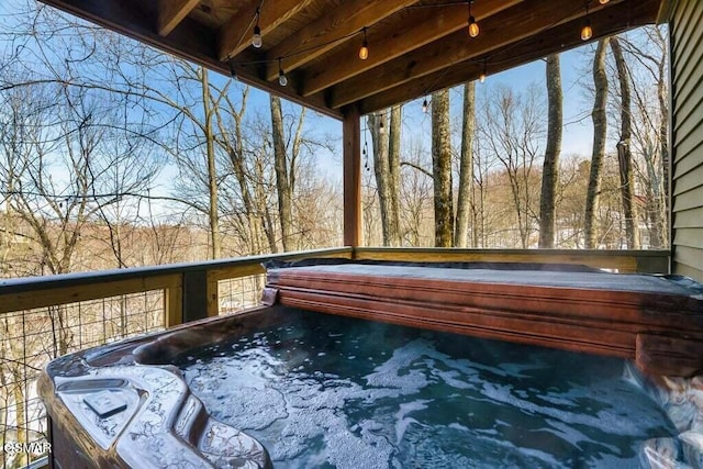 wooden terrace with a hot tub