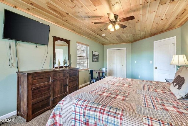 carpeted bedroom featuring a closet, crown molding, ceiling fan, and wooden ceiling