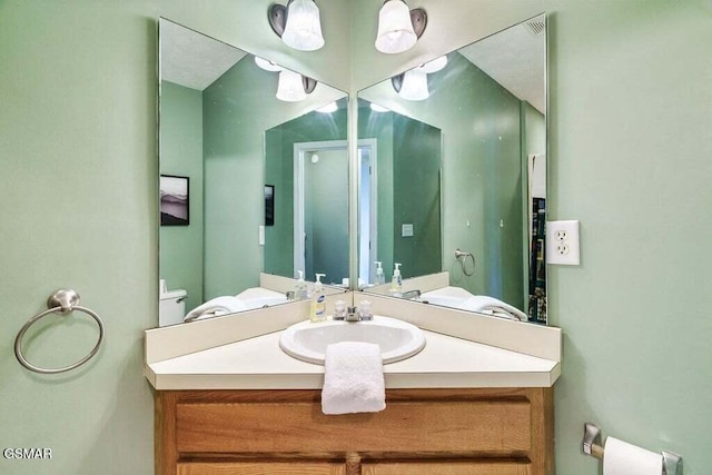 bathroom featuring vanity and toilet