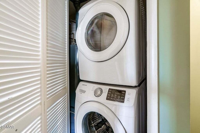 washroom featuring stacked washer and dryer