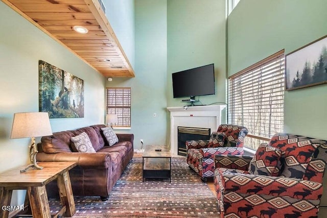 living room with a towering ceiling and wood ceiling