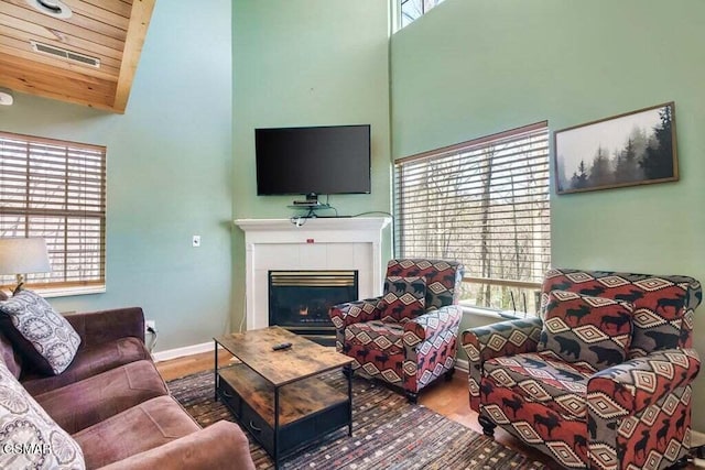 living room featuring plenty of natural light and a towering ceiling