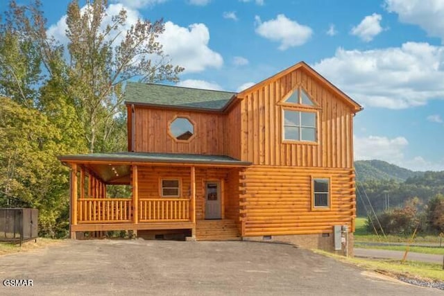 log-style house with a mountain view and a porch