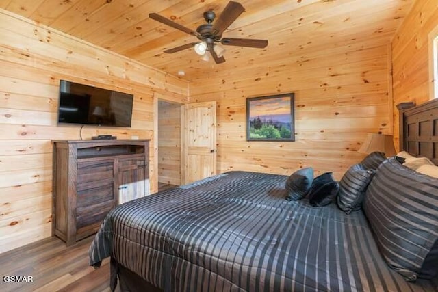 bedroom with hardwood / wood-style flooring, wood walls, and wood ceiling