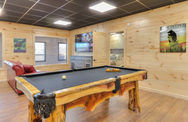 playroom with a paneled ceiling, hardwood / wood-style flooring, wooden walls, and pool table