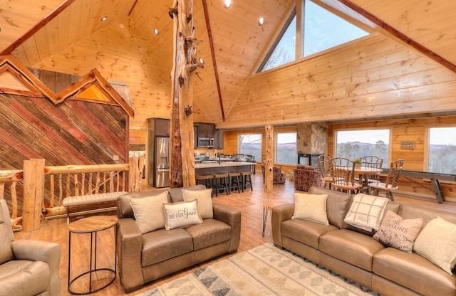 living room featuring wooden ceiling, high vaulted ceiling, wooden walls, and light hardwood / wood-style floors