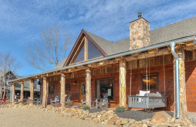 rear view of property with a porch