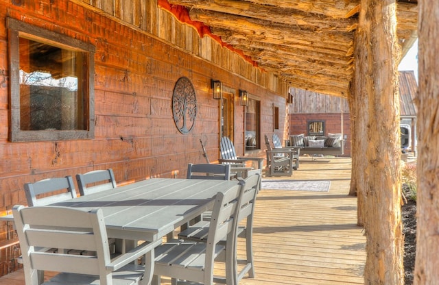 dining area featuring wood walls and lofted ceiling