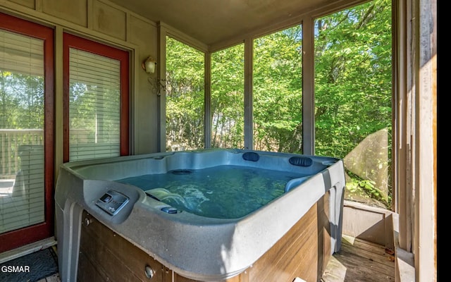 sunroom with a jacuzzi