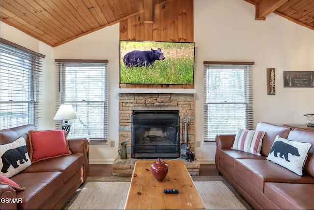 living room featuring lofted ceiling with beams, light hardwood / wood-style floors, a stone fireplace, and wood ceiling